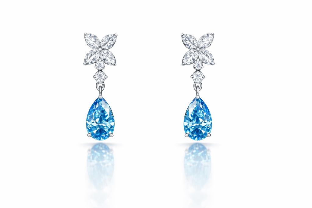 14K white gold earrings with blue marquise and round diamond drops, featuring elegant, sparkling gemstone details.
