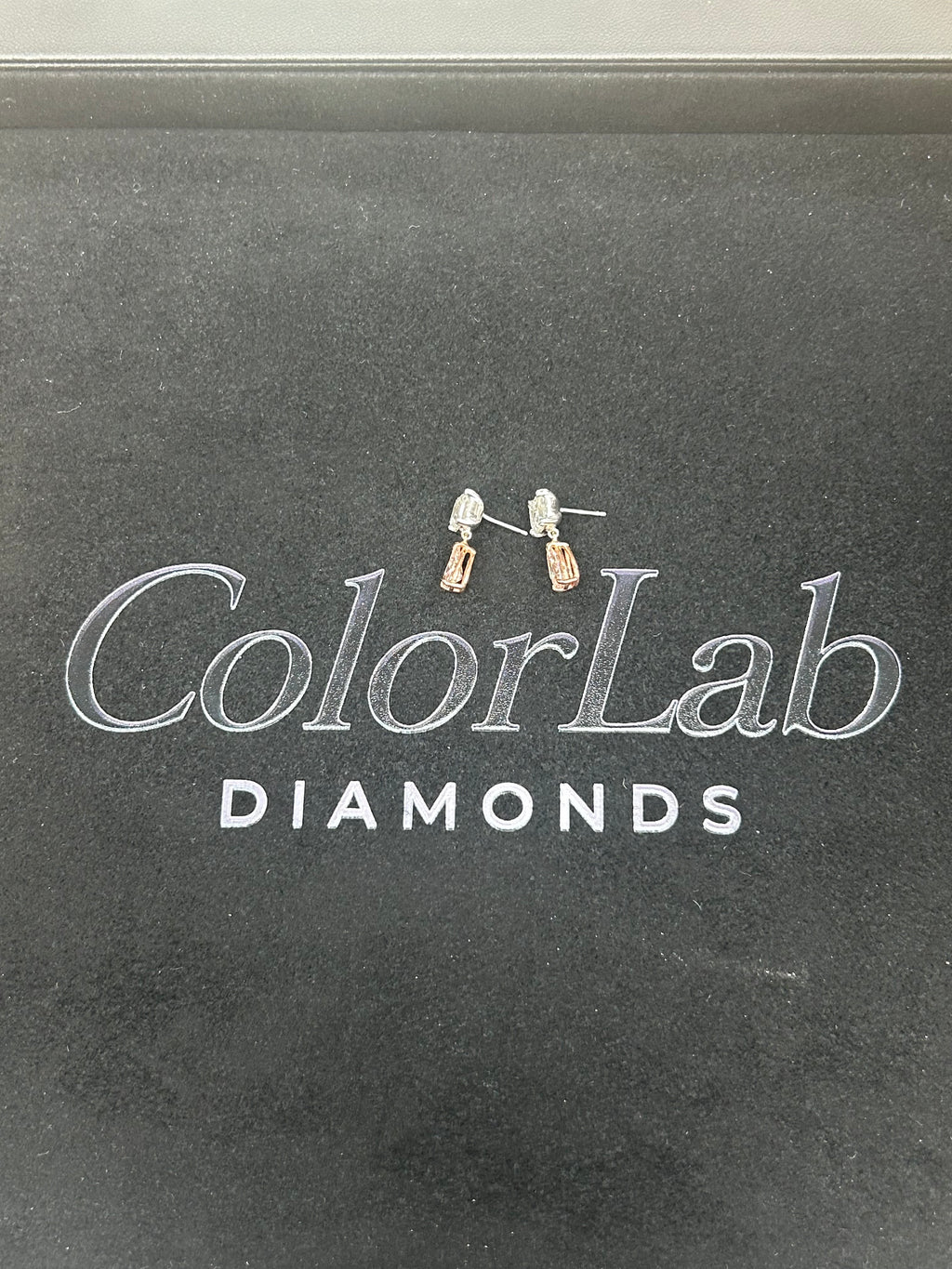 14K white and rose gold fancy pink diamond drop earrings with intricate design and sparkling pink diamonds.