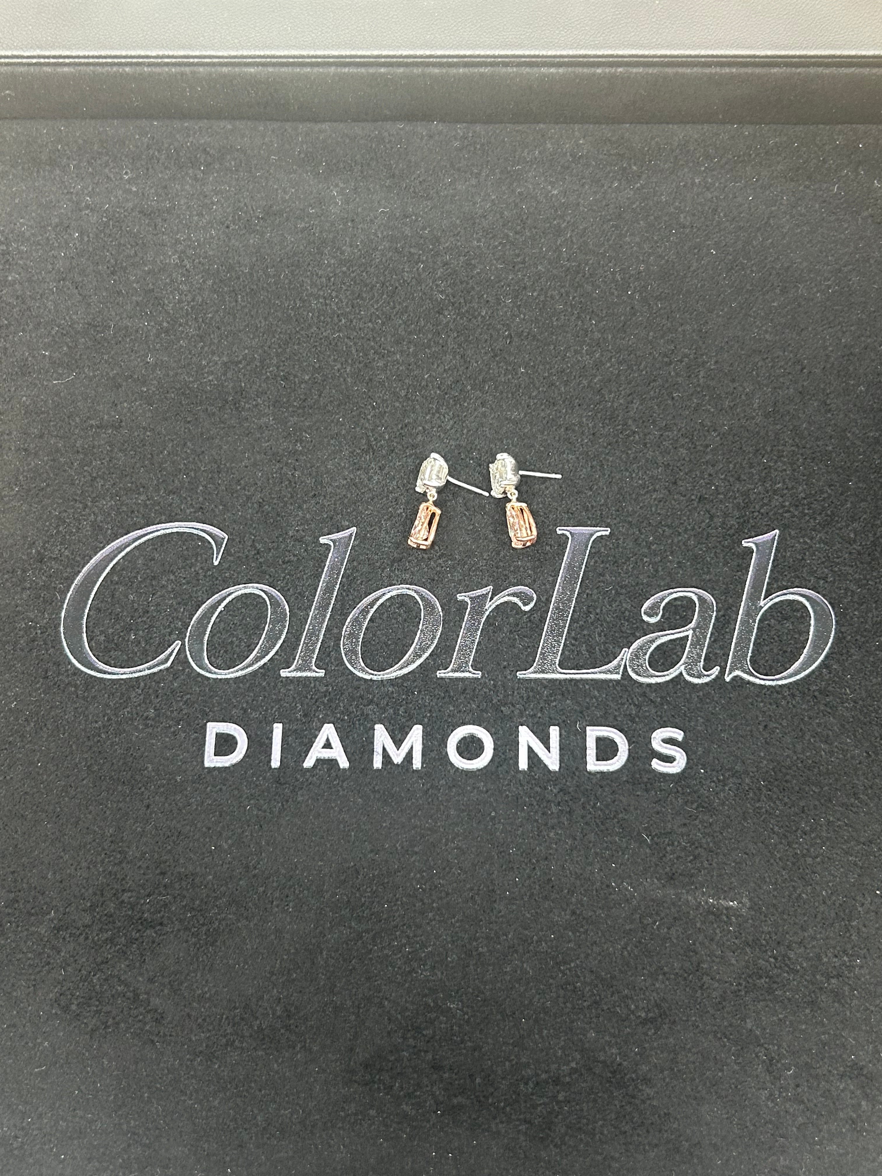 14K white and rose gold fancy pink diamond drop earrings with intricate design and sparkling pink diamonds.