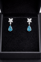 14K white gold fancy blue marquise and round diamond drop earrings with elegant design and sparkling gemstones.