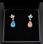 14K white gold fancy pink and blue diamond drop earrings with sparkling gemstone accents and elegant design.