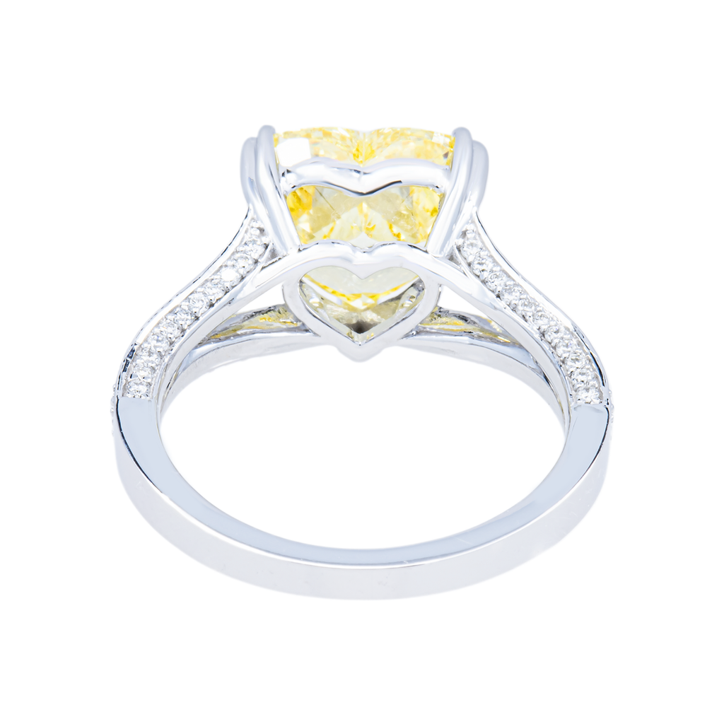 14K white gold fancy yellow heart-shaped diamond ring with IGI 4.59ctw, featuring intricate design and sparkling gemstones.