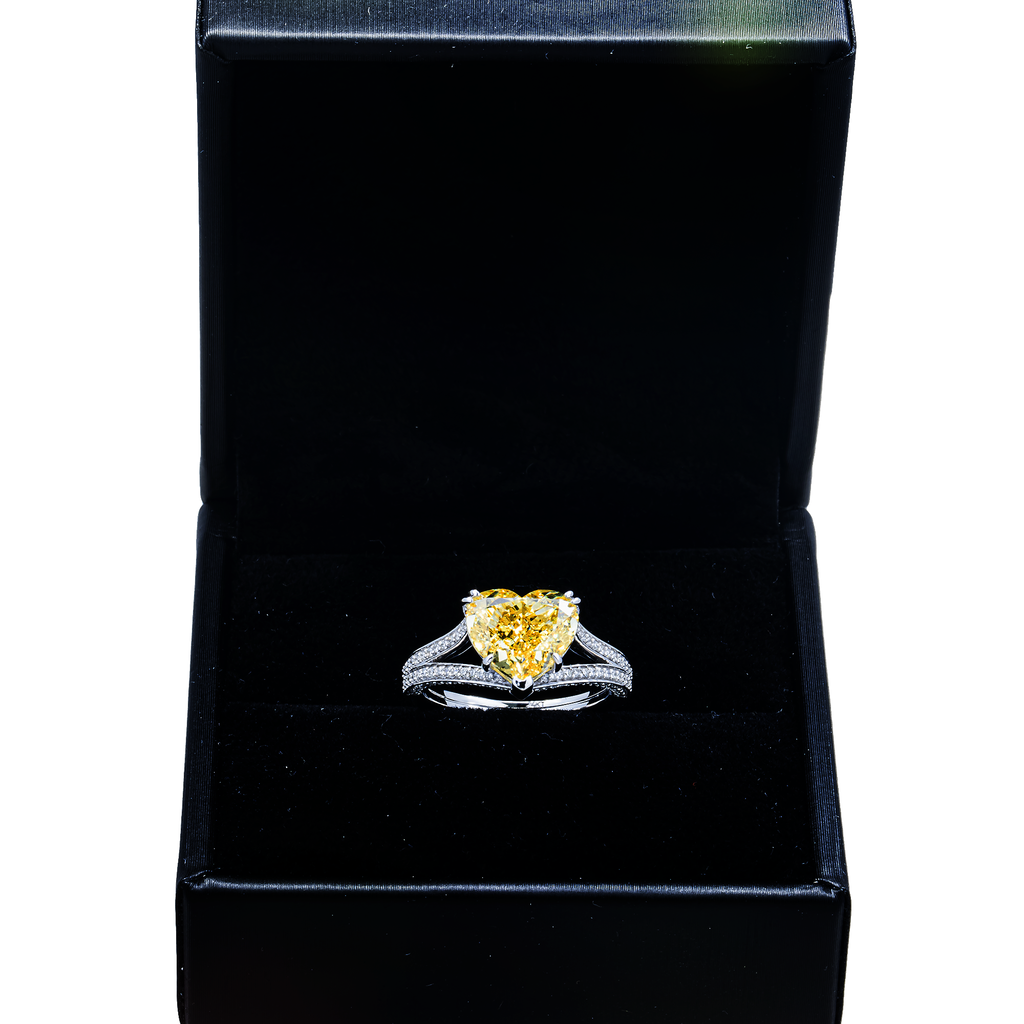 14K white gold fancy yellow heart-shaped diamond ring with IGI 4.59ctw, featuring sparkling yellow diamonds and intricate detailing.