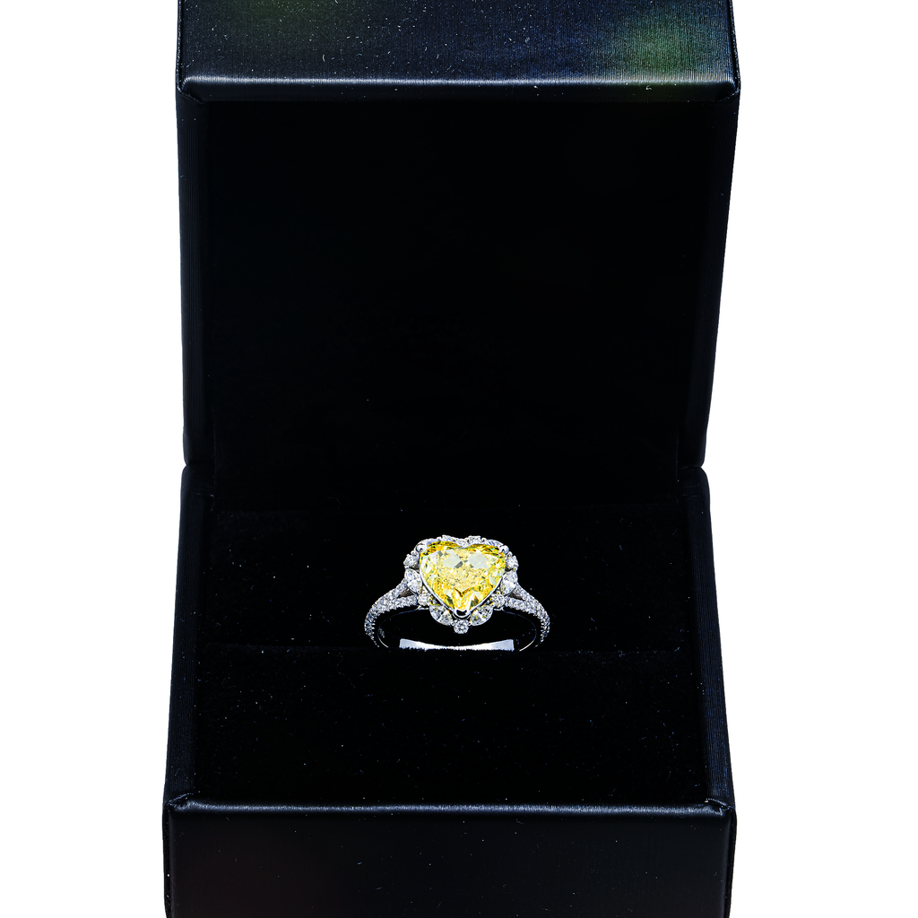 14K white gold ring with a yellow heart-shaped diamond and halo of pave diamonds, 3.69 carats total weight.