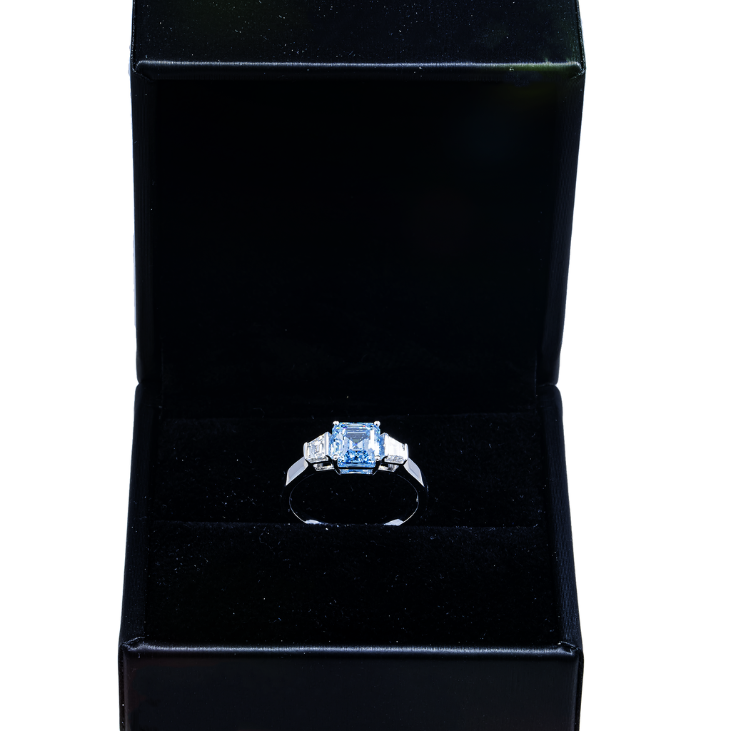 14KT white gold fancy blue Asscher cut diamond ring with intricate design, showcasing a stunning blue gemstone and sparkling accents.