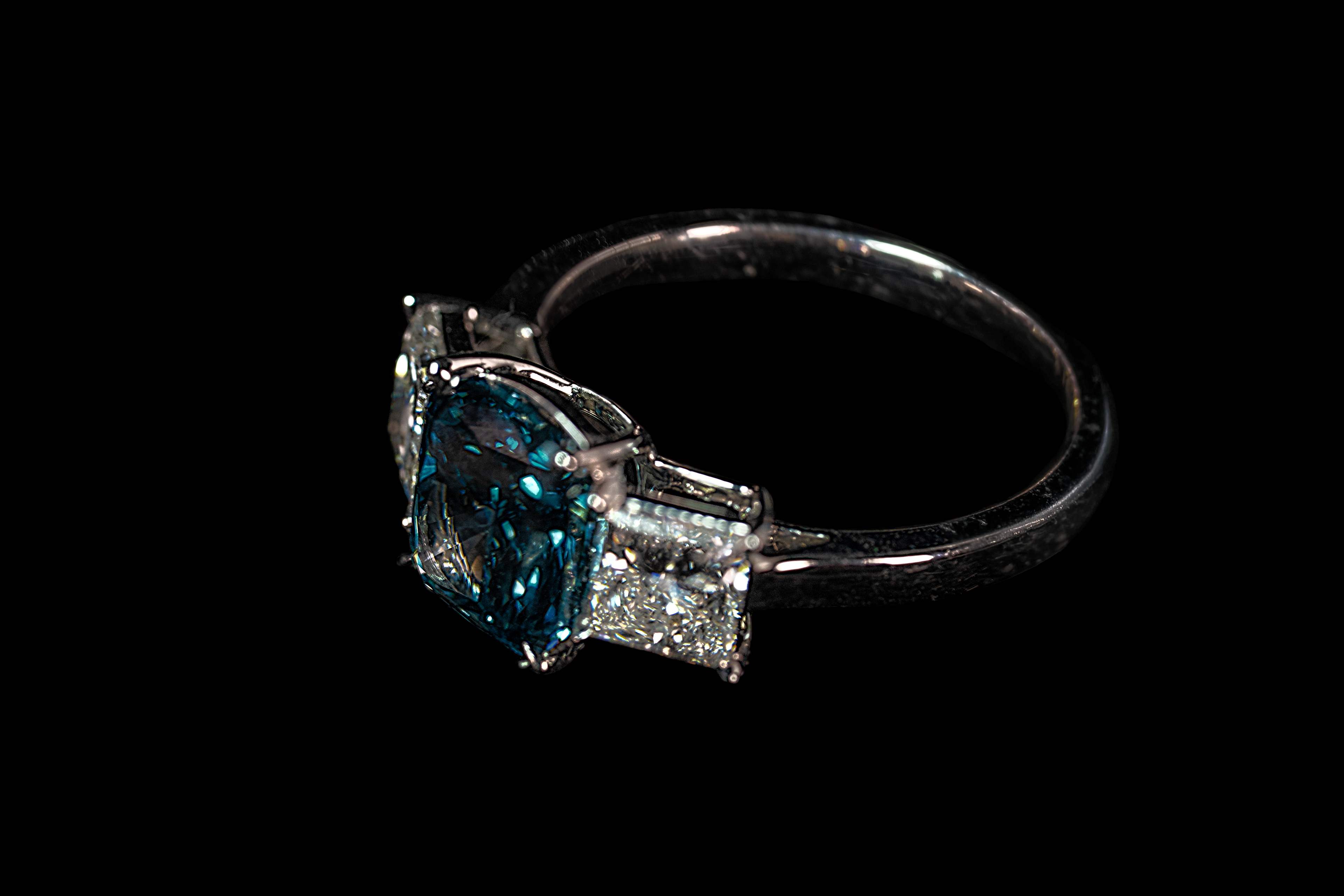 14K white gold fancy blue diamond ring with 3.17 CTW, featuring intricate design and sparkling blue diamonds.
