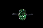 14K white gold solitaire oval ring with a 3.25-carat fancy green diamond, showcasing elegant jewelry craftsmanship.