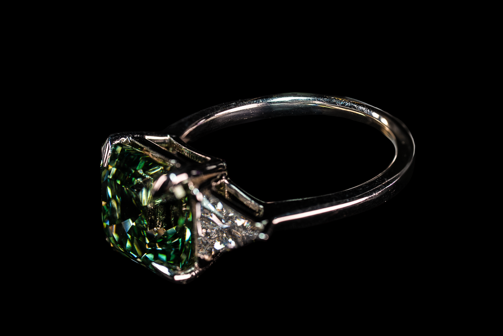 14K white gold ring featuring a 6.38 CTW fancy green Asscher cut diamond, showcasing elegant craftsmanship and vibrant color.